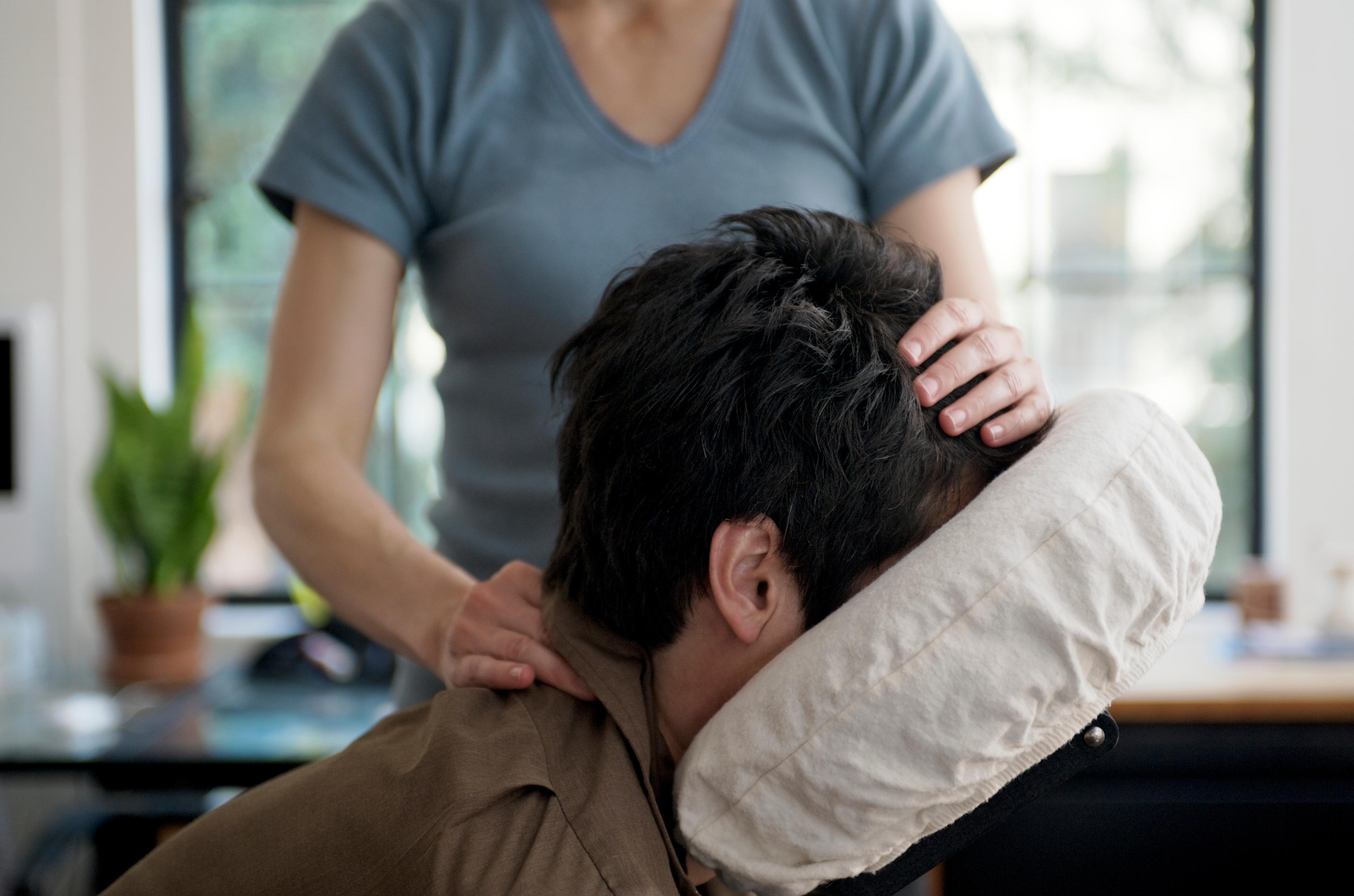 Man Getting Mobile Chair Massage in an Office